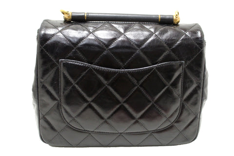 Authentic Chanel Black Aged Quilted Calfskin Leather Gold Bar Top Handle Medium Flap Bag