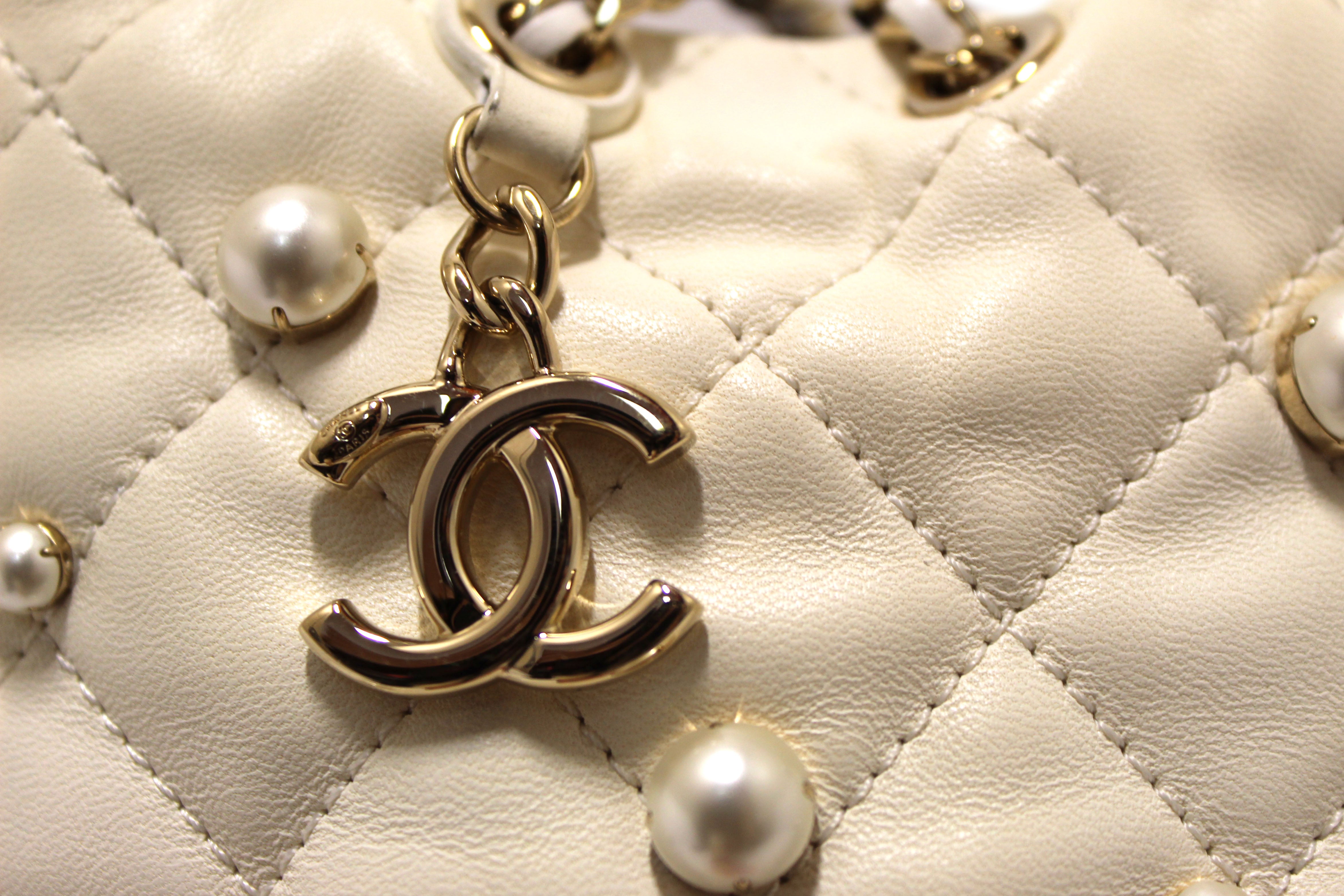 Authentic Chanel Quilted Lambskin with Pearls Mini Drawstring Bucket Bag