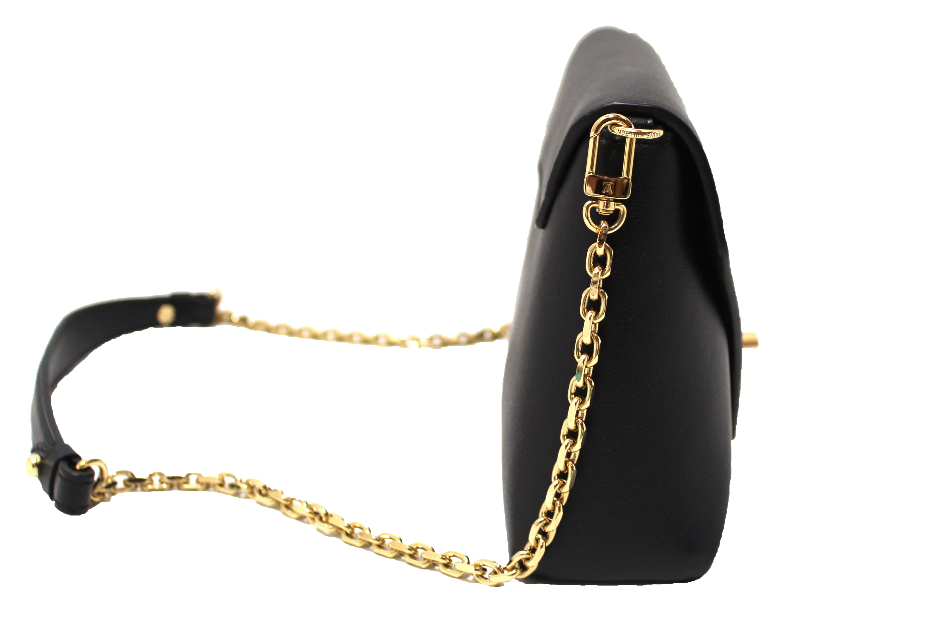 Louis Vuitton, Love note. Crafted in black leather with gold-toned LV turn-lock  closure and chain link. Turn lock closure opens to a black suede interior  with s…